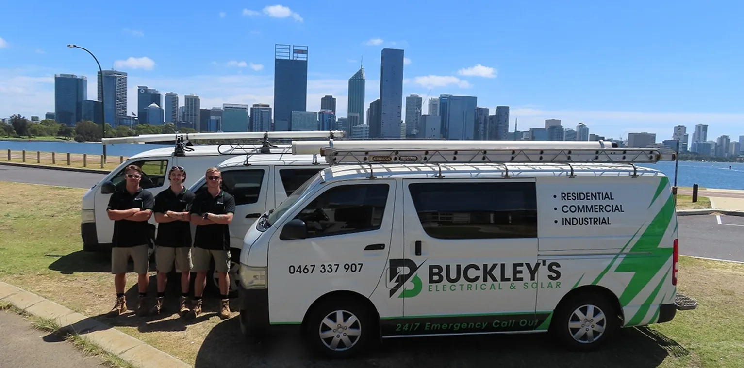 Isaac, Jacob, and Joey Buckley standing in front of the Buckley's Electrical & Solar van with the Perth skyline behind them